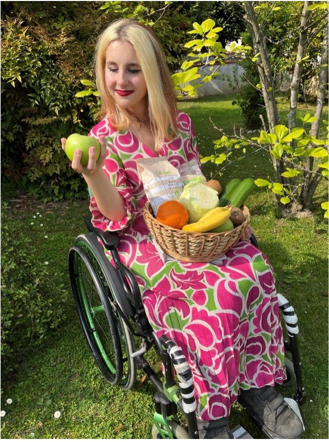 A photo of me under fruit trees holding a basket of produce
